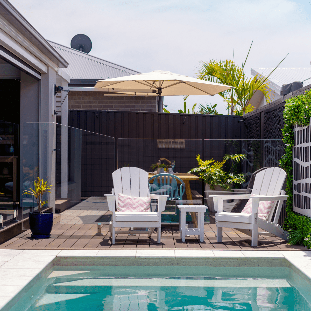 Shadowspec Retreat Wall Mounted umbrella at outdoor deck with pool