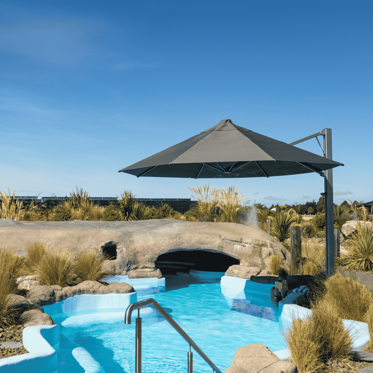 Shadowspec Serenity Rotating Cantilever umbrella with octagonal canopy at a resort poolside