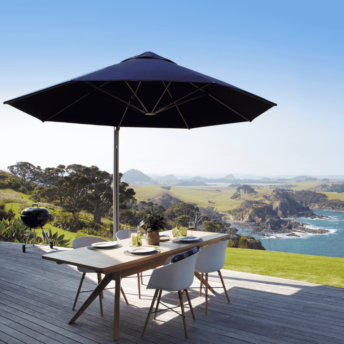 Shadowspec Serenity Rotating Cantilever Umbrella with octagonal canopy at a residential patio overlooking the ocean