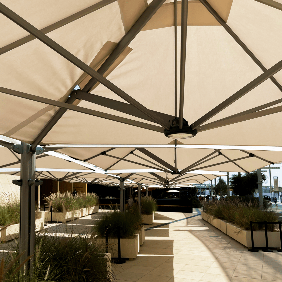 Shadowspec Unity Quattro Multi-Canopy Cantilever umbrellas at a resort terrace