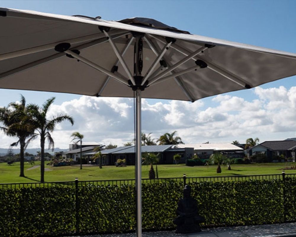 shadowspec Oasis Cafe and Resort umbrella on a residential deck overlooking garden