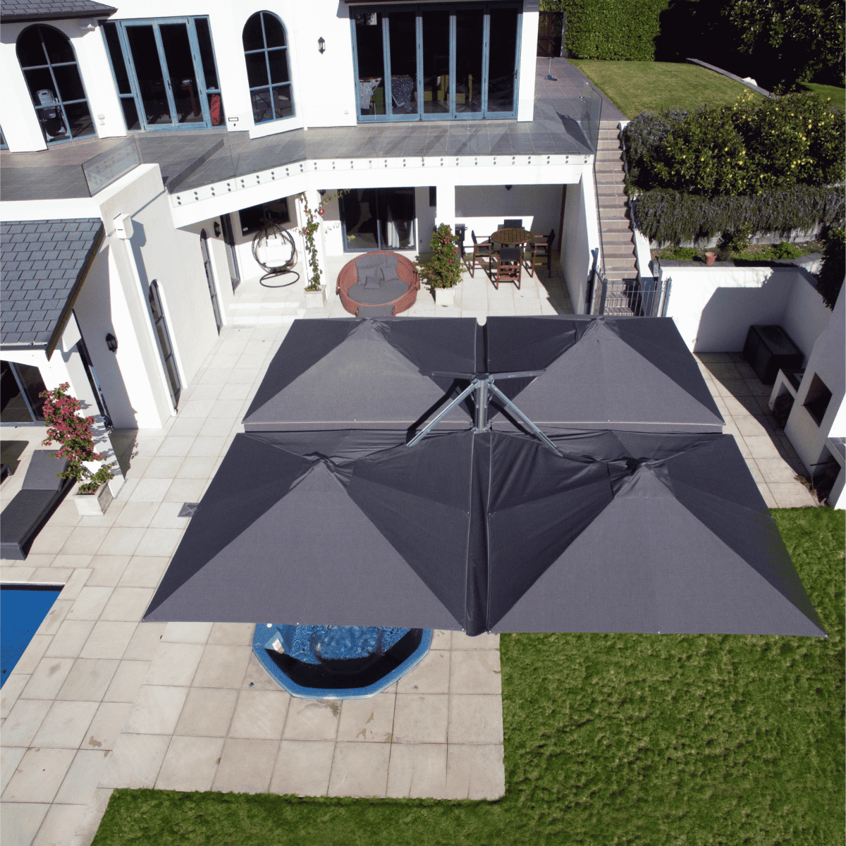 Arial view of Shadowspec Unity Quattro Multi-Canopy Cantilever umbrella in a residential setting
