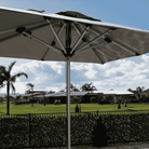 Shadowspec Oasis Cafe and Resort Center Pole umbrella with square canopy in a residential garden