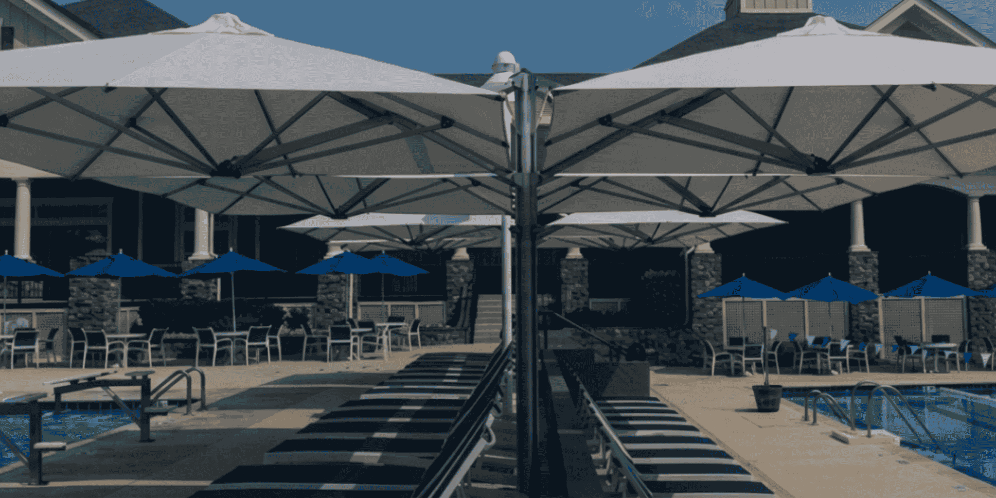 Shadowspec Oasis and unity duo umbrellas near a swimming pool at a country club