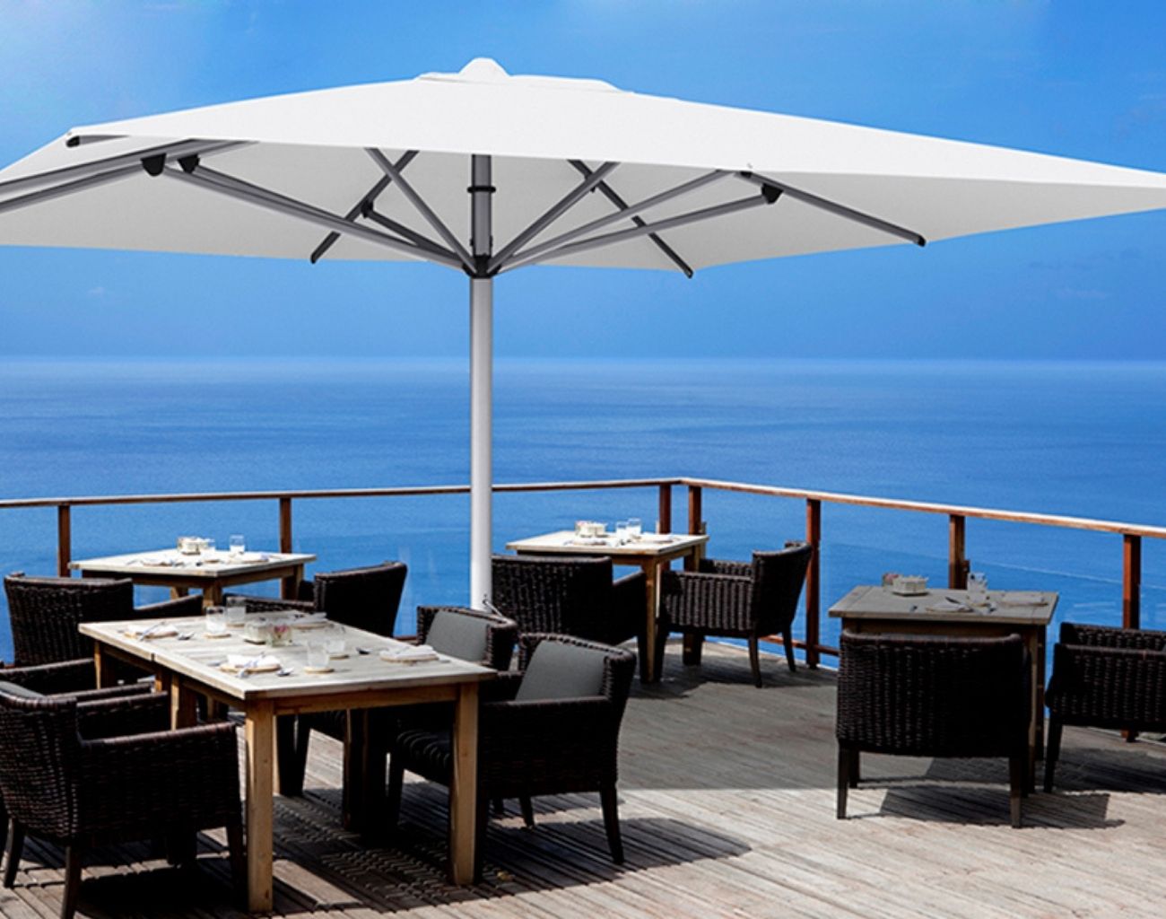 Shadowspec Center Pole umbrella in commercial setting overlooking scenic view