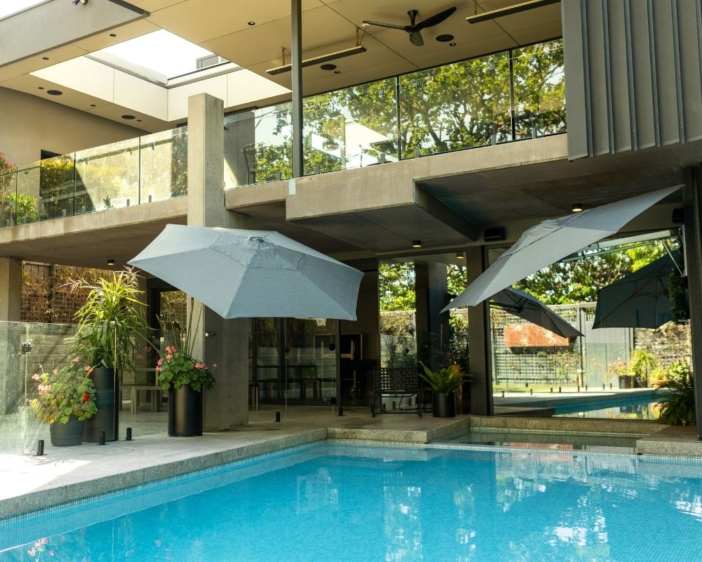 Shadowspec Retreat umbrellas installed at a residential poolside