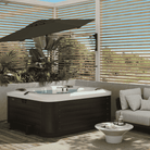 Shadowspec Retreat Wall Mounted umbrella at outdoor spa on patio