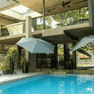 Shadowspec Retreat Wall Mounted umbrella at luxurious patio with pool