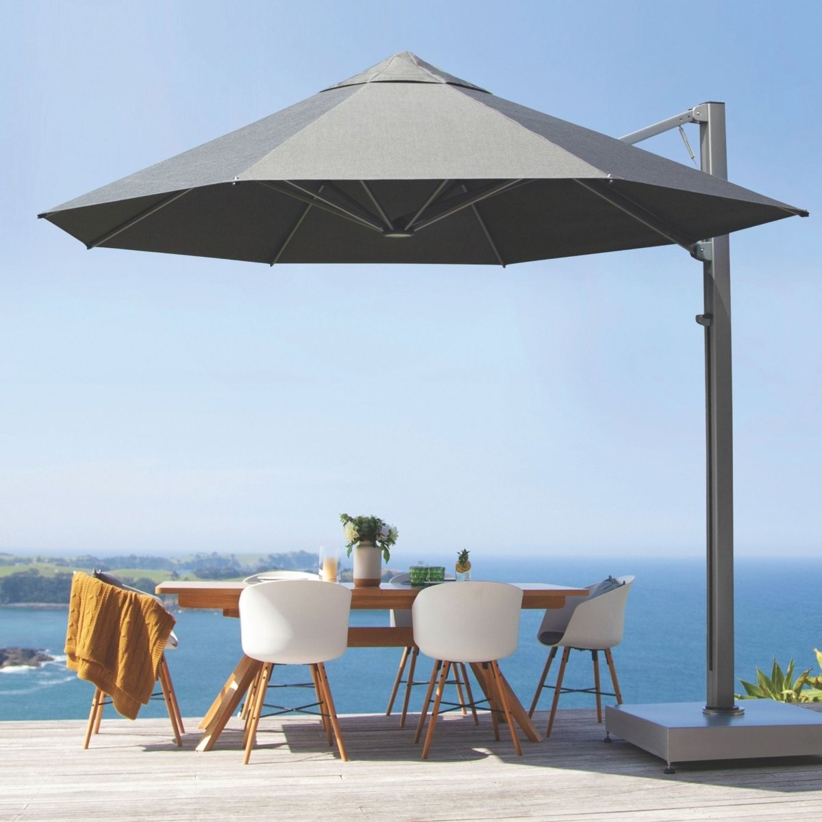 Shadowspec Serenity Rotating Cantilever Umbrella with scenic ocean view in the background