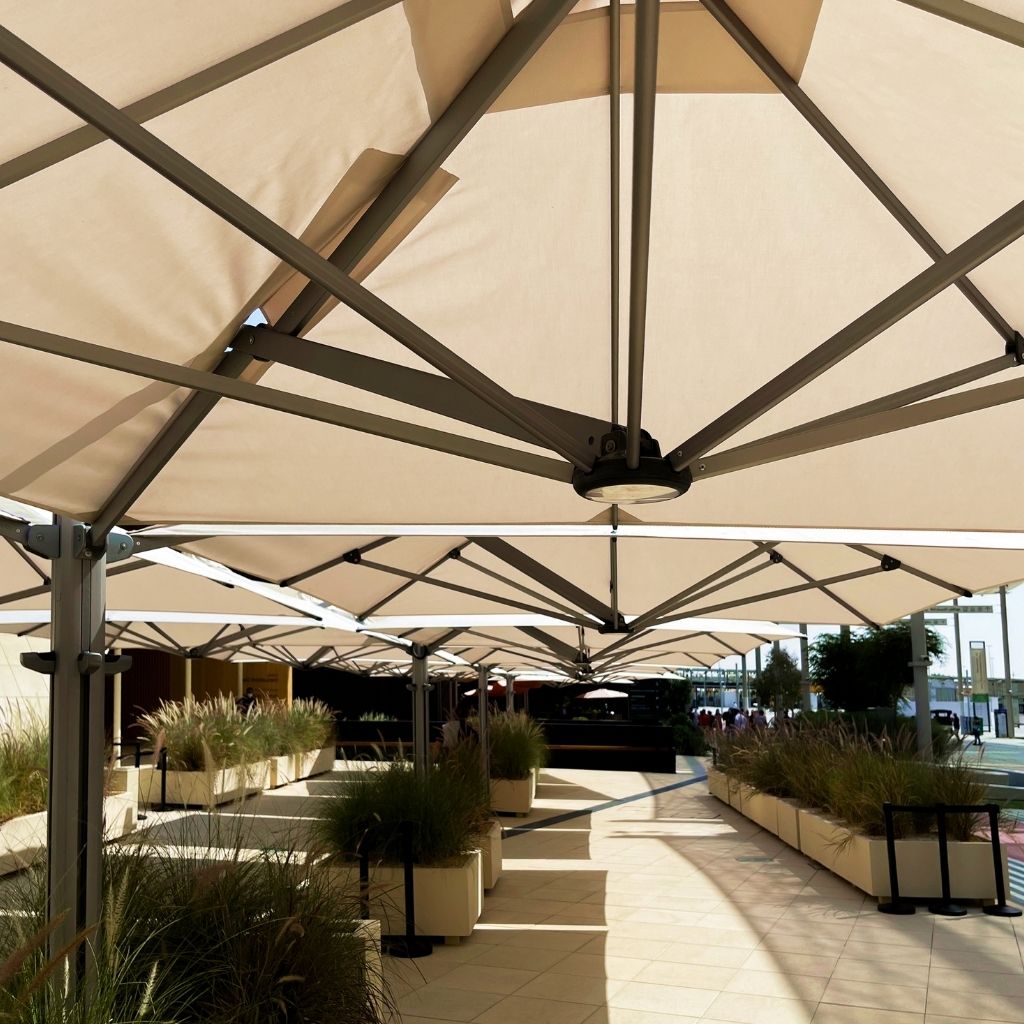 Shadowspec Unity Quattro umbrellas installed at resort outdoor lounge area