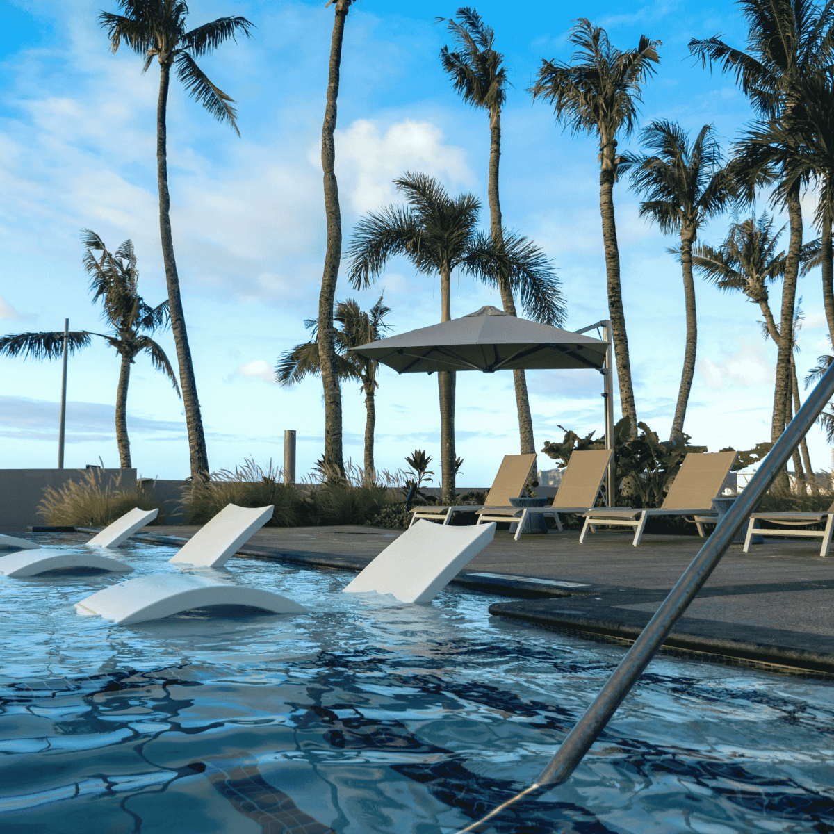 Shadowspec Serenity Rotating Cantilever umbrella with octagonal canopy around a  resort style pool