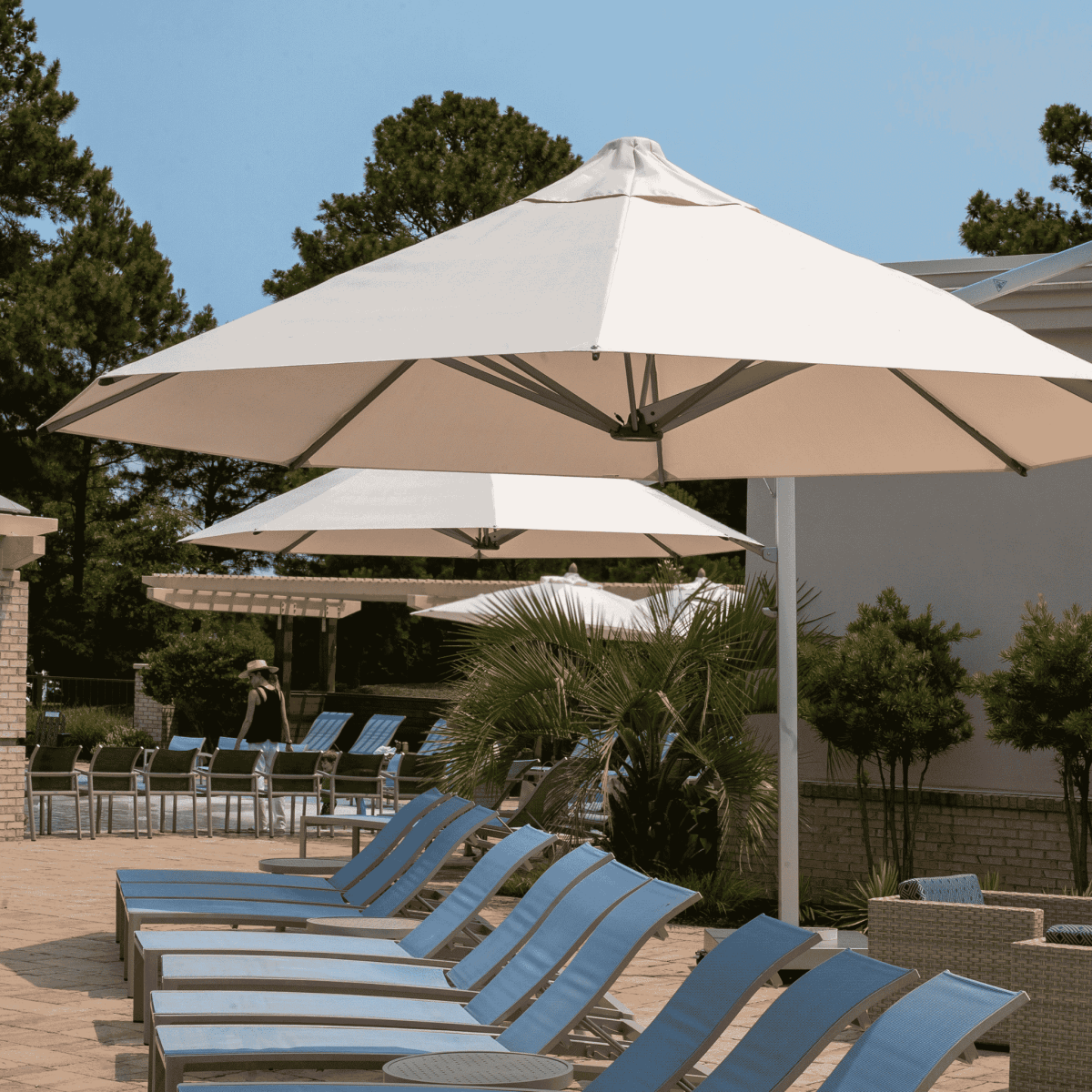 Shadowspec Serenity Rotating Cantilever umbrella with octagonal canopy at a resort pool side