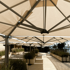 Shadowspec Unity Quattro Multi-Canopy Cantilever umbrellas at a resort terrace