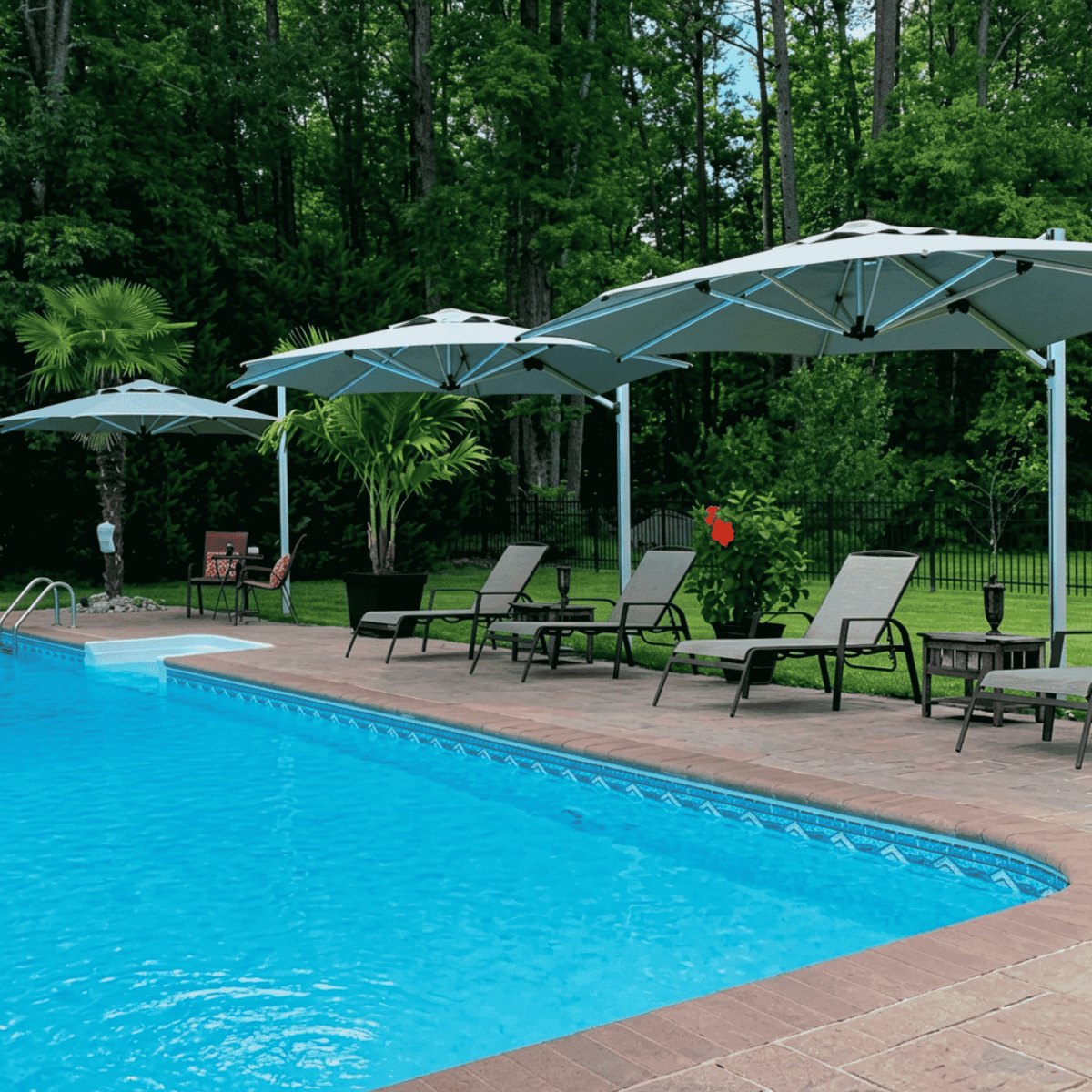 Shadowspec Tilting Offset umbrella with octagon canopy around a resort pool